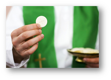 Priest holding out the Eucharist in Holy Communion