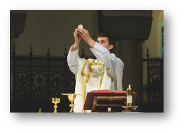 Priest holding up the Eucharist during the Holy Sacrifice of the Mass